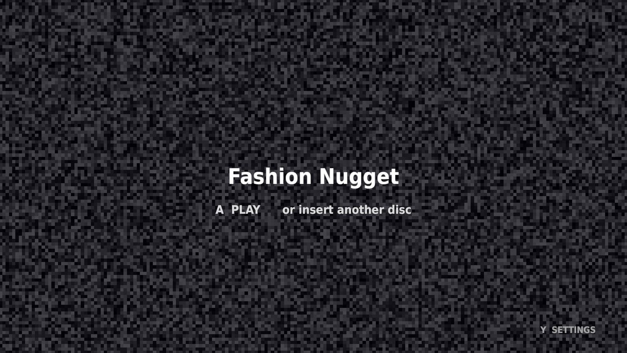 An idle screen of animated TV static with the words Fashion Nugget in large text, and below it a dimmer line reading A PLAY, or insert another disc.